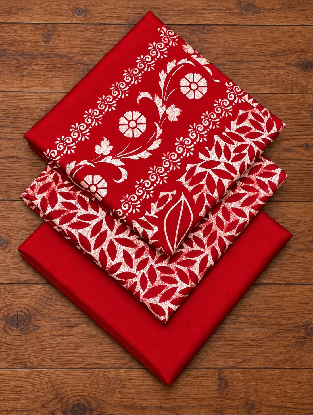 Folded red Dhanak block-print shirt, printed dupatta and plain trouser fabric