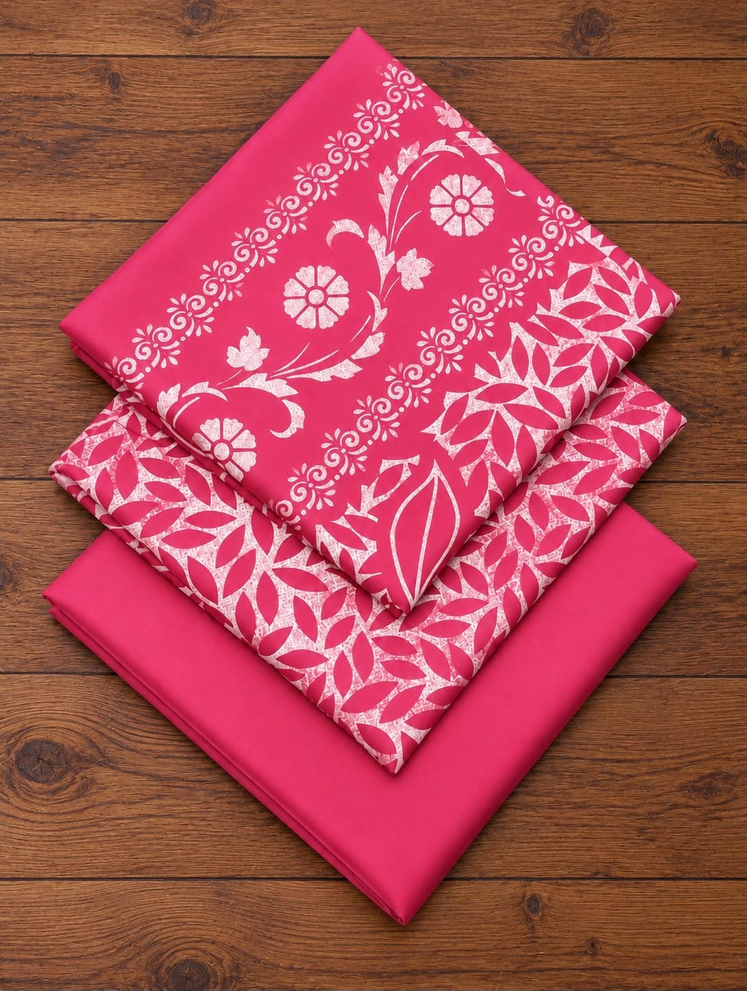 Folded pink Dhanak block-print shirt, printed dupatta and plain trouser fabric