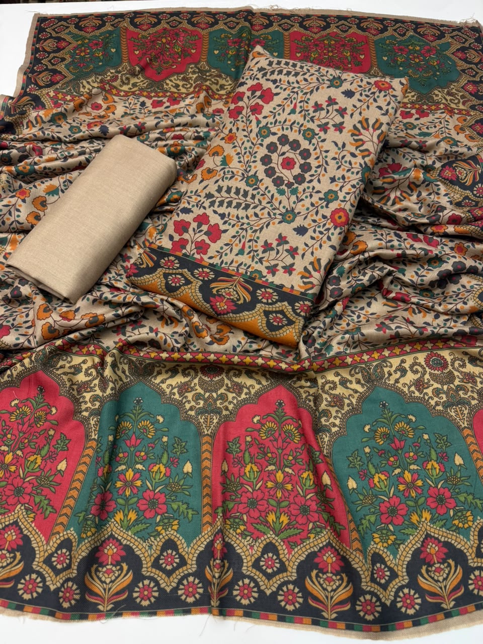 Flat lay of Kalamkari shirt, printed shawl and plain wool trouser fabric