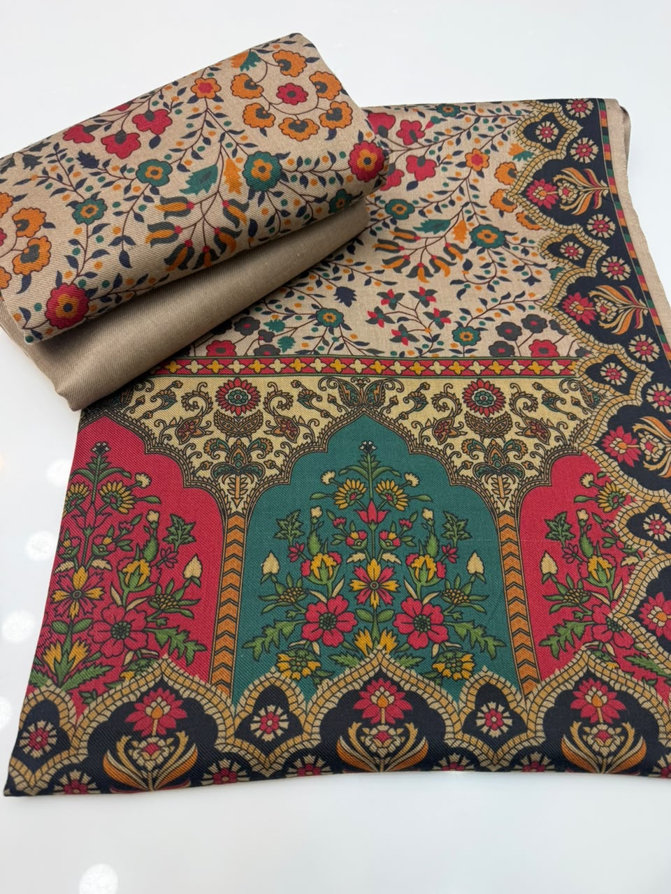 Folded Kalamkari shirt fabric beside the shawl border panel